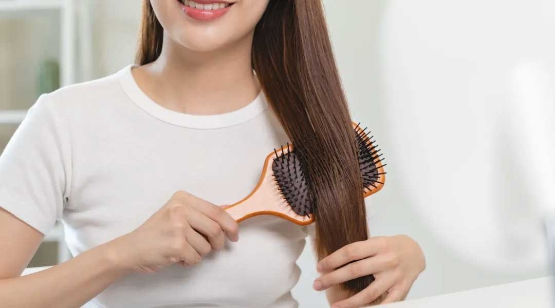 Wanita dengan rambut lebat dan sehat karena menggunakan Kérastase shampoo, shampo penumbuh rambut terbaik